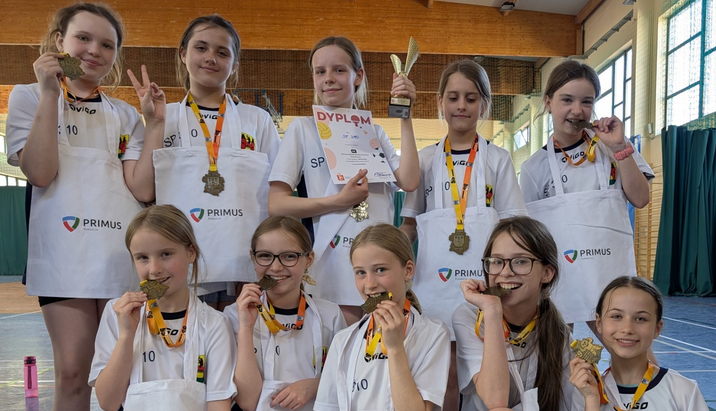 Uczennice w strojach sportowych biorą udział w zawodach w dwa ognie
